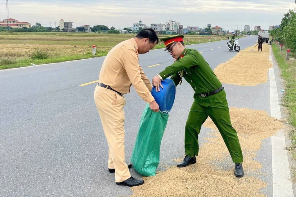 Công an xuống đường dọn thóc lúa phòng tránh tai nạn giao thông - 1