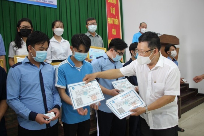 Giám đốc Bảo hiểm xã hội An Giang Đặng Hồng Tuấn trao tặng thẻ bảo hiểm y tế cho học sinh, sinh viên.