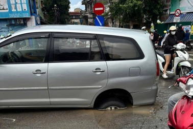Hà Nội: Ô tô đang đi trên đường bất ngờ bị tụt bánh xuống hố