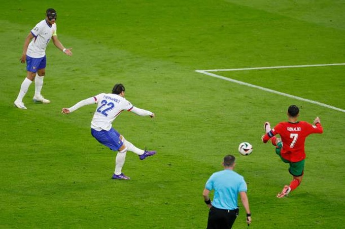 frances-defender-theo-hernandez-kicks-the-ball-past-portugals-forward-cristiano-ronaldo.jpg