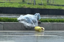 Giải cứu người phụ nữ nằm giữa đường trong lúc trời mưa bão