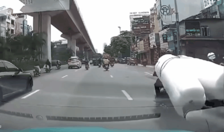Tài xế chở hàng cồng kềnh khiến người đi xe máy bị ngã xuống đường - 1