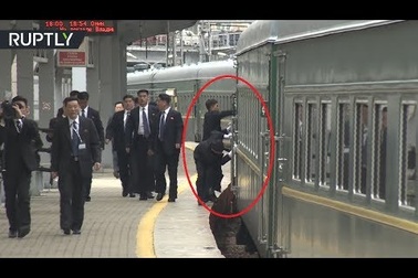 Vệ sĩ của ông Kim Jong-un chạy theo tàu để lau cửa