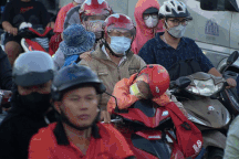 Trẻ em ngủ gục trên xe máy theo cha mẹ rời TPHCM về quê nghỉ lễ