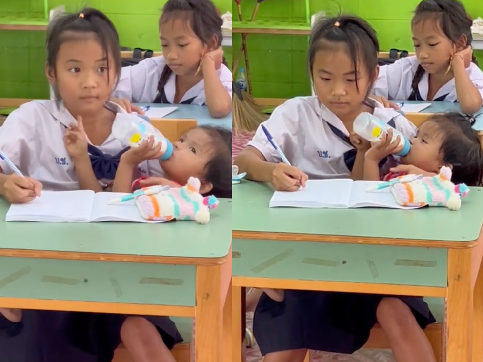 Video bé gái 10 tuổi vừa nghe giảng, vừa bế em gây xúc động - 1
