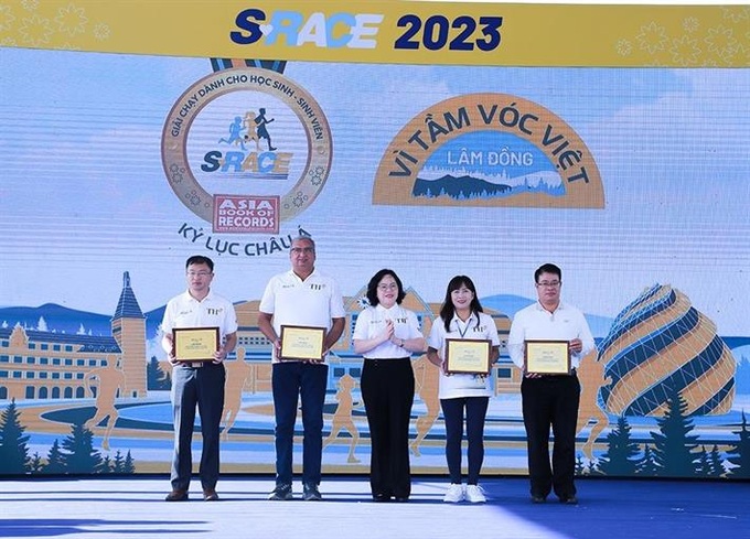 Thứ trưởng Ngô Thị Minh trao kỷ niệm chương cho các đơn vị đồng hành với giải chạy S-Race Lâm Đồng.