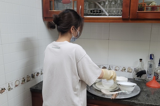 Phương Chi giúp mẹ dọn dẹp, rửa bát đĩa tại nhà riêng, sáng 16/7, với các kỹ năng có được trong quá trình đi làm thêm. Ảnh: Minh Đức
