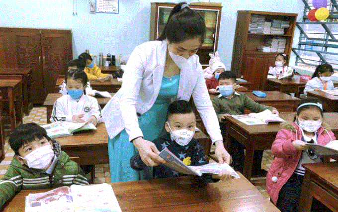 Giáo viên Trường Tiểu học Lương Thế Vinh (quận Sơn Trà) hướng dẫn học sinh tư thế cầm sách. Ảnh: Ngọc Hà/Baodanang