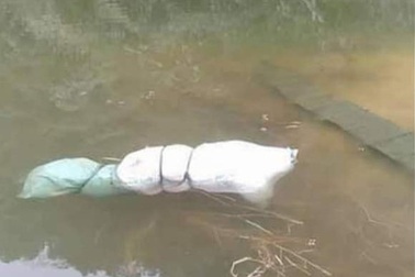 Thi thể một phụ nữ bị buộc chặt trong bao tải nổi trên mặt hồ