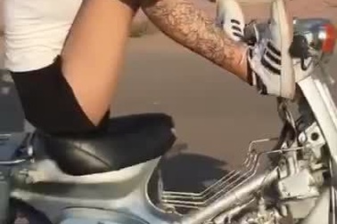 Tay bận dùng điện thoại, thiếu nữ điều khiển xe máy bằng chân