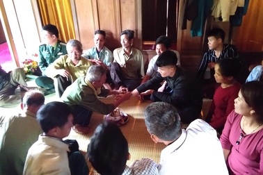 Buộc chỉ cổ tay cầu bình an cho con trước khi lên đường nhập ngũ