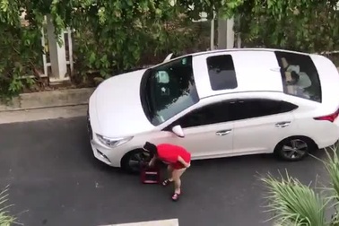 Ô tô bị khóa bánh, người phụ nữ lấy kìm cắt khóa và bỏ đi trong 30 giây