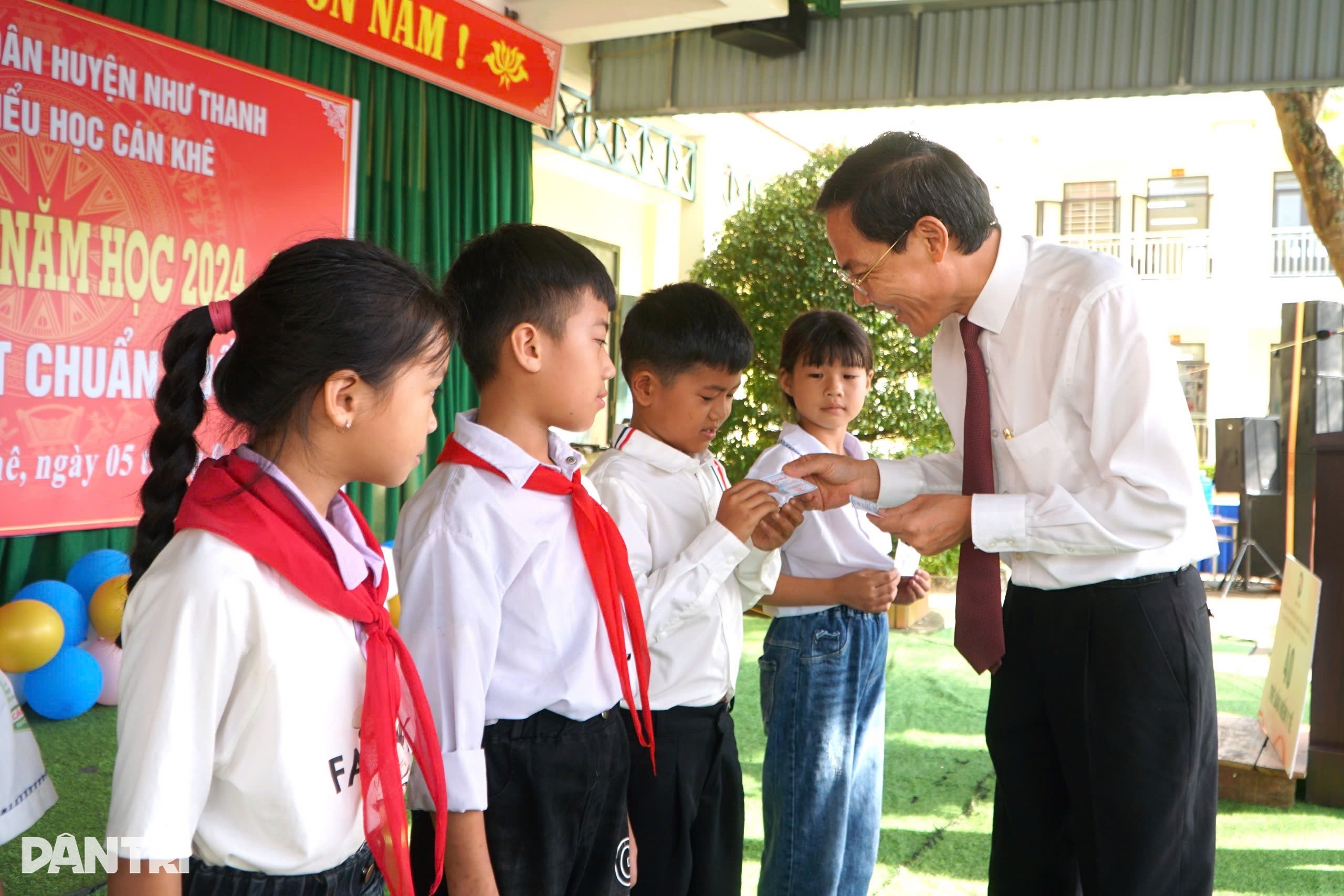 Ông Đầu Thanh Tùng trao tặng thẻ BHYT do báo Dân trí tài trợ đến các học sinh (Ảnh: Hạnh Linh).