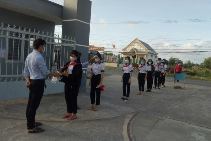 Giáo viên tiến hành đo thân nhiệt, giúp các em rửa tay diệt khuẩn,... trước khi bước vào trường.