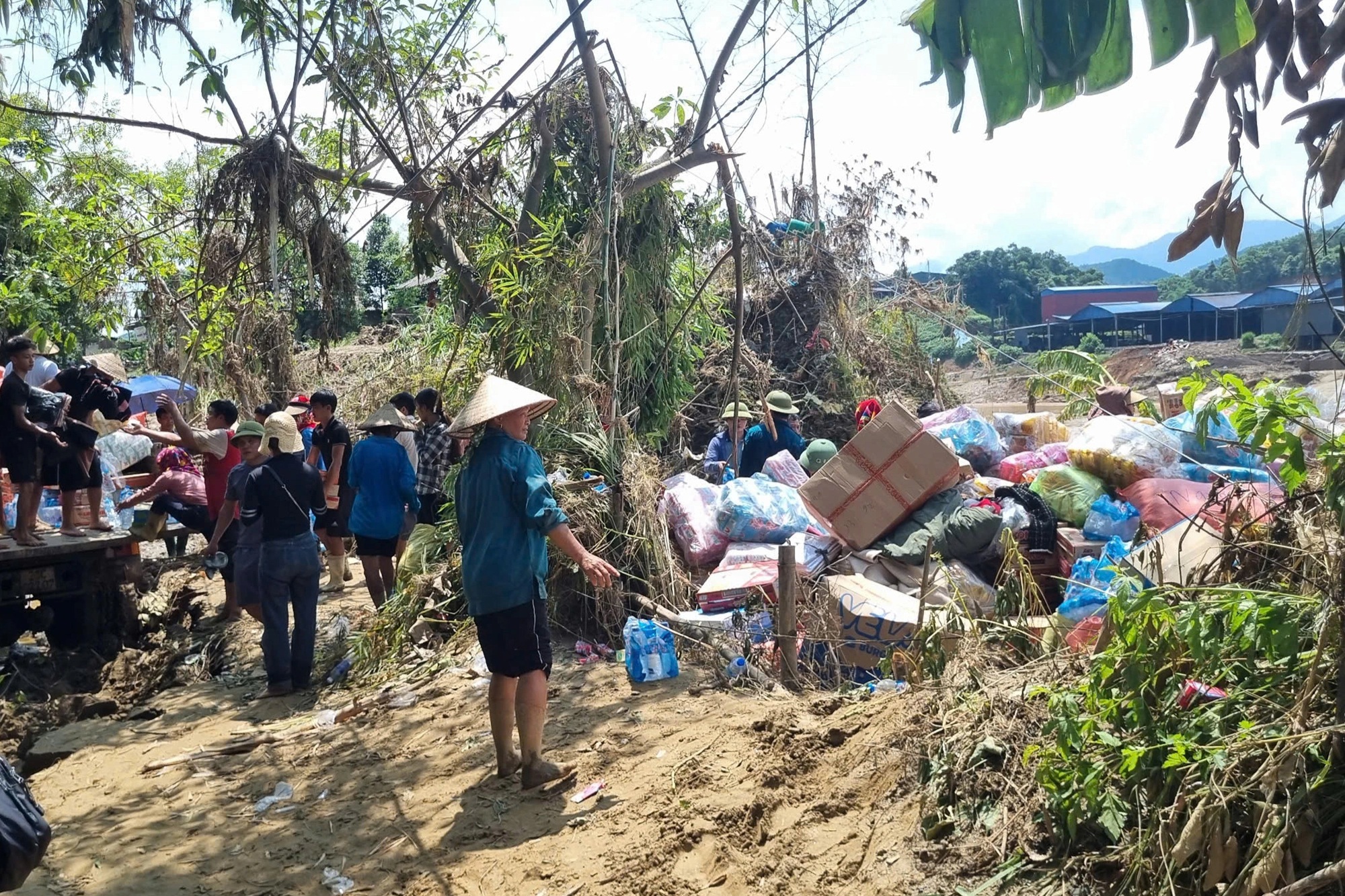 Người dân thôn 3 Vanh hỗ trợ đoàn cứu trợ đưa hàng hóa về khu tập trung để chuyển tới từng hộ dân (Ảnh: Hữu Kiên).