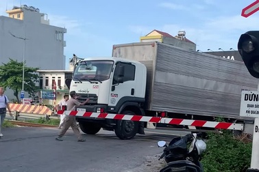 Ô tô tải cố vượt rào chắn đường sắt, người dân ép tài xế lùi xe