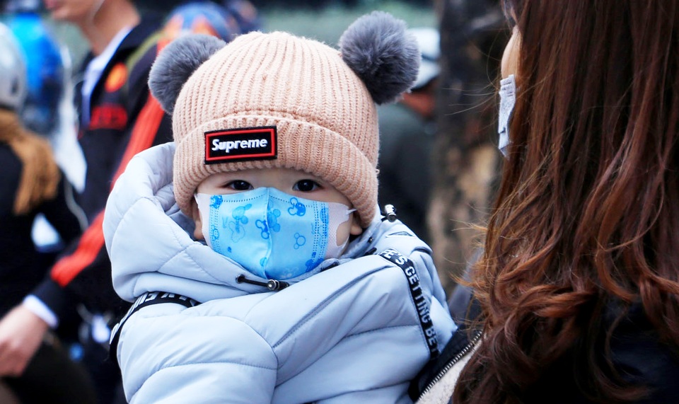 Trẻ em được bố mẹ bọc kín mít đi đường trong tiết trời lạnh giá ở Hà Nội - 6