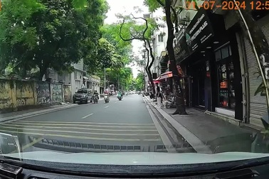 Ô tô chạy lấn làn ngược chiều để vượt, xô người đi xe máy bật ngửa