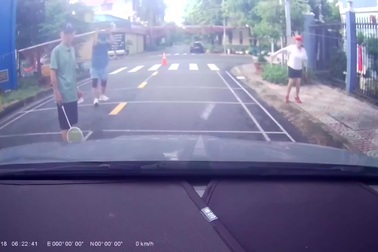 Nhóm người lớn tuổi thản nhiên giăng lưới, đánh cầu lông giữa đường