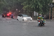 Người dân dắt xe máy, lội trên đường phố ngập sâu sau mưa lớn ở Thanh Hóa