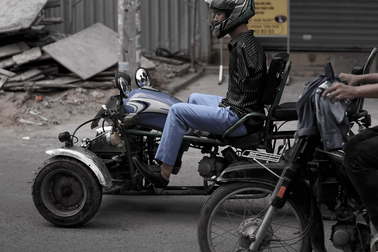 Chàng trai không tay lái xe máy bằng hai chân