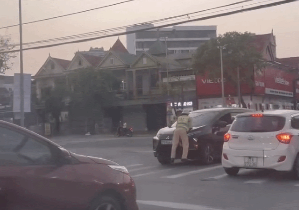 Ô tô lao nhanh khi một cảnh sát giao thông bám trên nắp capo - 1 Ô tô lao nhanh khi một cảnh sát giao thông bám trên nắp capo - 1