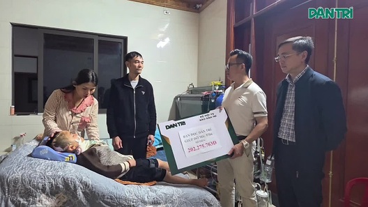 Đại diện báo Dân trí trao quà của bạn đọc tới gia đình bé Minh Khang