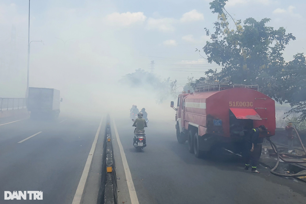 TPHCM: Khói trắng bao phủ quốc lộ, hàng trăm người bịt mũi vượt qua - 1