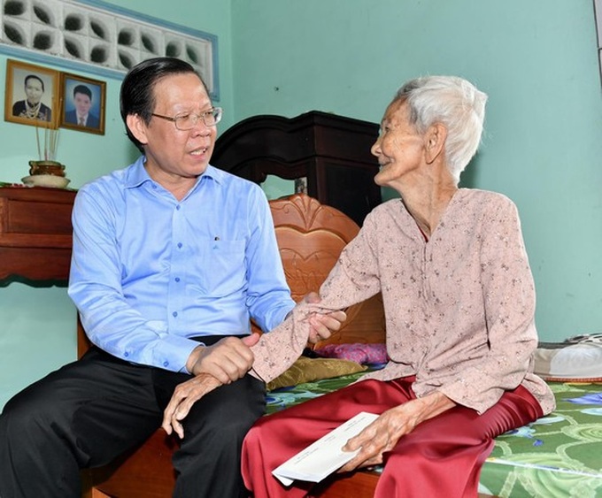 Chủ tịch UBND TPHCM Phan Văn Mãi thăm hỏi Mẹ Việt Nam Anh hùng Bùi Thị Tám. Ảnh: VIỆT DŨNG