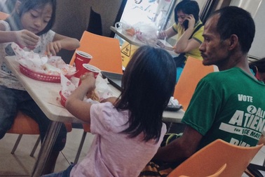 Câu chuyện cảm động sau bức ảnh bố nhịn đói nhìn con ăn gà rán