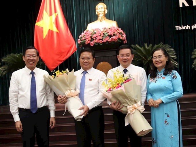 Chủ tịch UBND TPHCM Phan Văn Mãi (bìa trái) cùng Chủ tịch HĐND TPHCM Nguyễn Thị Lệ trao hoa chúc mừng ông Nguyễn Toàn Thắng (thứ 3 từ trái qua) và ông Lê Văn Thinh (thứ 2 từ trái qua).