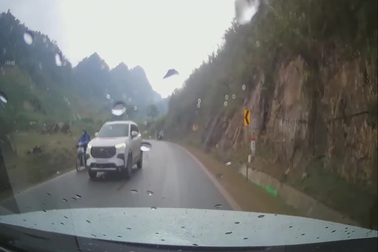 Cặp đôi đi xe máy trượt ngã khi vào cua, suýt lao vào ô tô ngược chiều