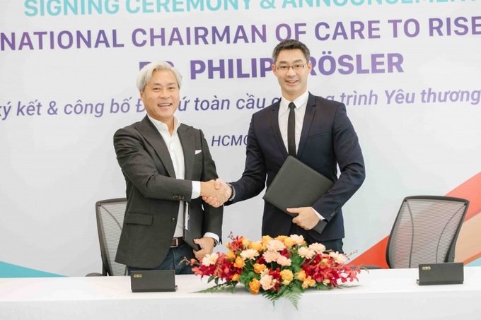 Ông Don Lam và Tiến sĩ Philipp Rösler bắt tay sau khi ký kết thỏa thuận hợp tác.