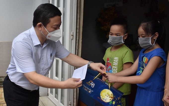 Phó Chủ tịch UBND TP HCM Dương Anh Đức tặng quà cho các em mồ côi vì COVID-19 ở quận Gò Vấp. Ảnh: Báo NLĐ
