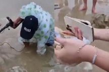 Tìm điện thoại cho nữ du khách vì chôn xuống cát lúc tắm biển