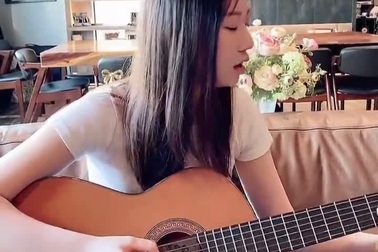 Chân Tế Như vừa hát vừa chơi đàn guitar