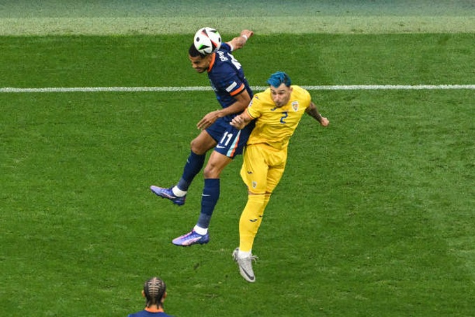 netherlands-forward-cody-gakpo-and-romanias-defender-andrei-ratiu-both-jump-to-head-the-ball.jpg