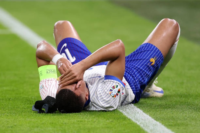 hamburg-germany-kylian-mbappe-of-france-holds-his-nose-as-he-goes-down-with-an-injury-during.jpg