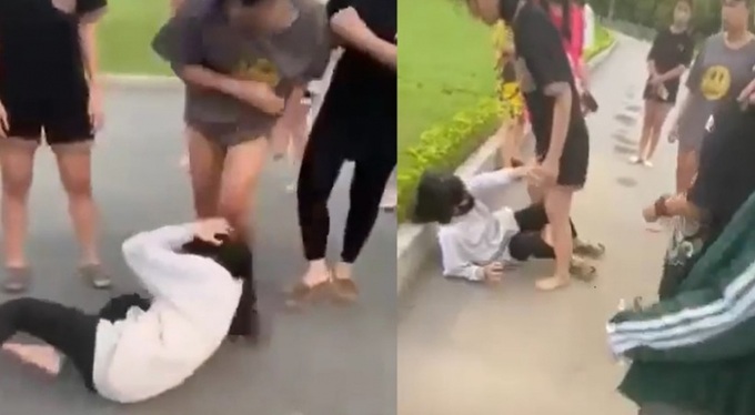 Nữ sinh áo trắng bị một nhóm người khác túm tóc, đánh hội đồng. Ảnh cắt từ clip