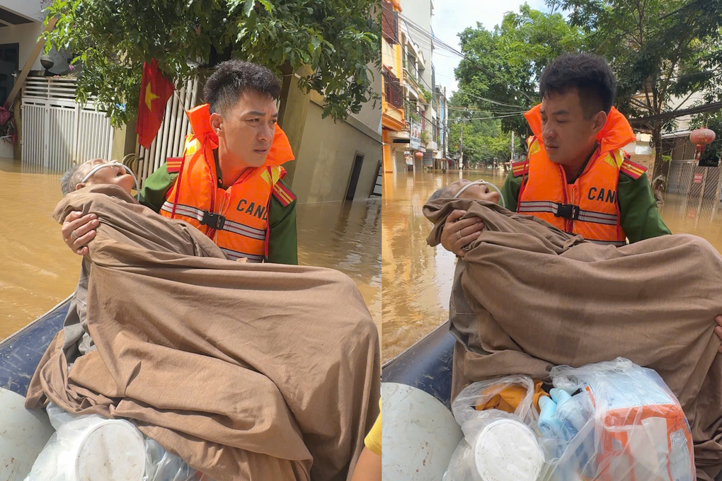 Video chiến sĩ công an bế cụ bà nguy kịch vượt lũ đi cấp cứu gây xúc động - 1 Video chiến sĩ công an bế cụ bà nguy kịch vượt lũ đi cấp cứu gây xúc động - 1