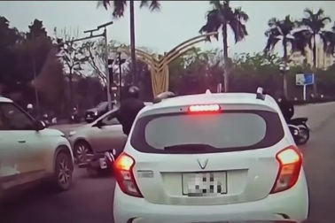 Va chạm giao thông, người đi xe máy dùng mũ bảo hiểm đập vỡ cửa kính ô tô