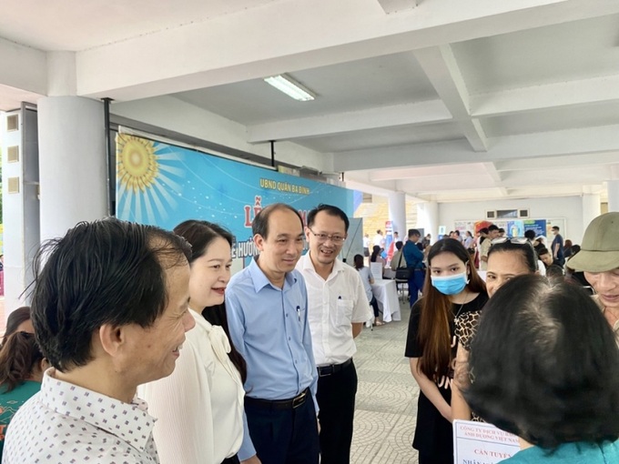 Ông Nguyễn Tây Nam, Phó Giám đốc sở LĐ-TB&XH Hà Nội (áo xanh) và các đại biểu thăm hỏi, chia sẻ với người lao động tham gia tìm việc làm tại phiên GDVL lưu động quận Ba Đình năm 2023.