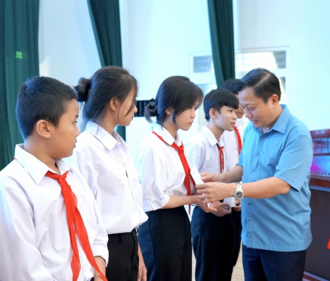 Ông Hà Quốc Trị - Phó Bí thư Tỉnh ủy, Trưởng đoàn Đại biểu Quốc hội tỉnh trao học bổng cho các học sinh.
